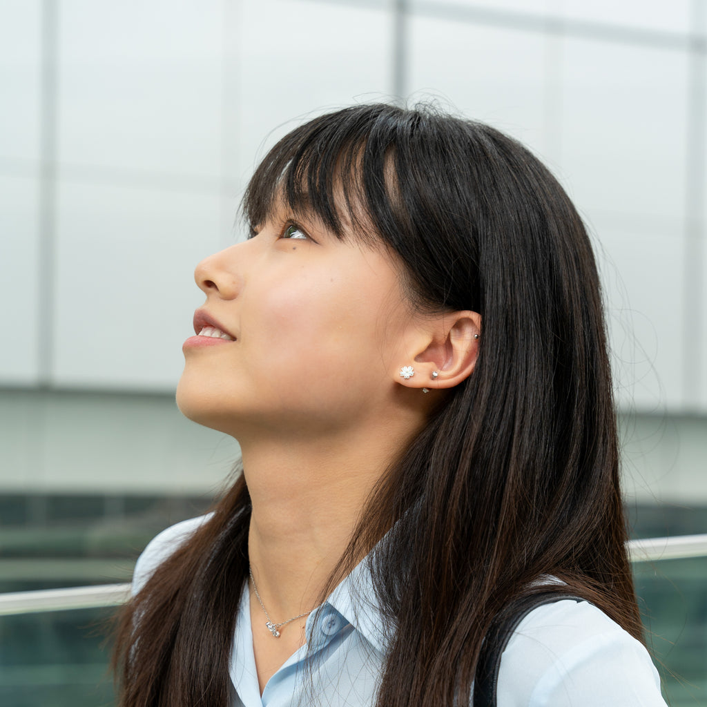 girl wearing flower earrings